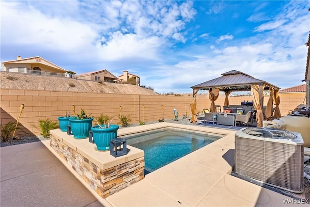 view of swimming pool with a gazebo, a patio, and a fenced backyard