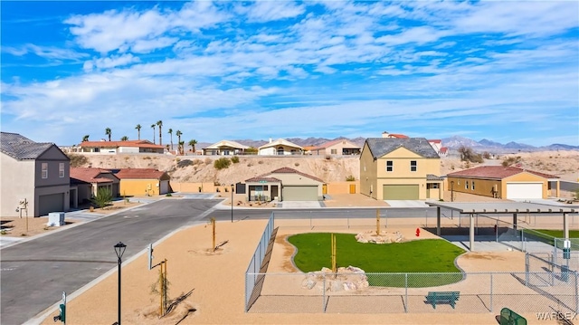 exterior space with a mountain view, street lights, and a residential view