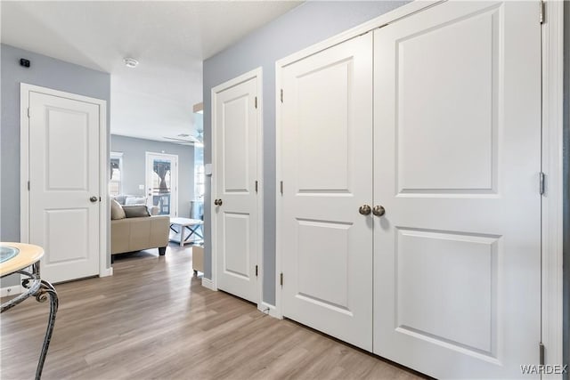 corridor featuring light wood finished floors