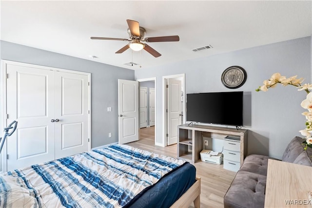 bedroom with a closet, visible vents, light wood-style flooring, a ceiling fan, and baseboards