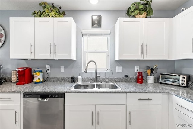 kitchen featuring a sink, a toaster, white cabinets, and dishwasher