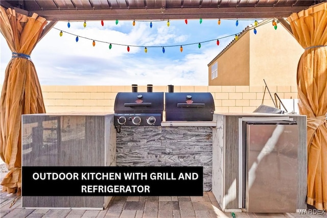 view of patio featuring exterior kitchen, a grill, and a pergola