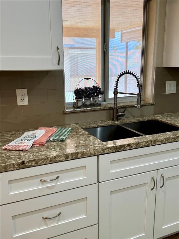 2023 E Sundance Dr, Fort Mohave, AZ 86426 - kitchen with a sink, backsplash, white cabinets, and plenty of natural light