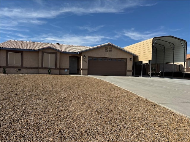2023 E Sundance Dr, Fort Mohave, AZ 86426 - ranch-style house featuring concrete driveway, an attached garage, stucco siding, and a carport