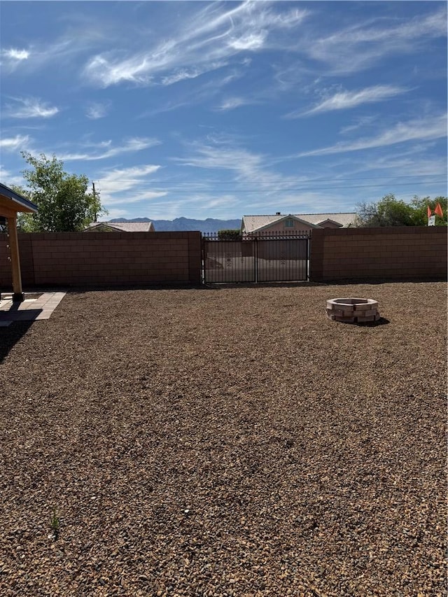 2023 E Sundance Dr, Fort Mohave, AZ 86426 - fenced backyard with a fire pit
