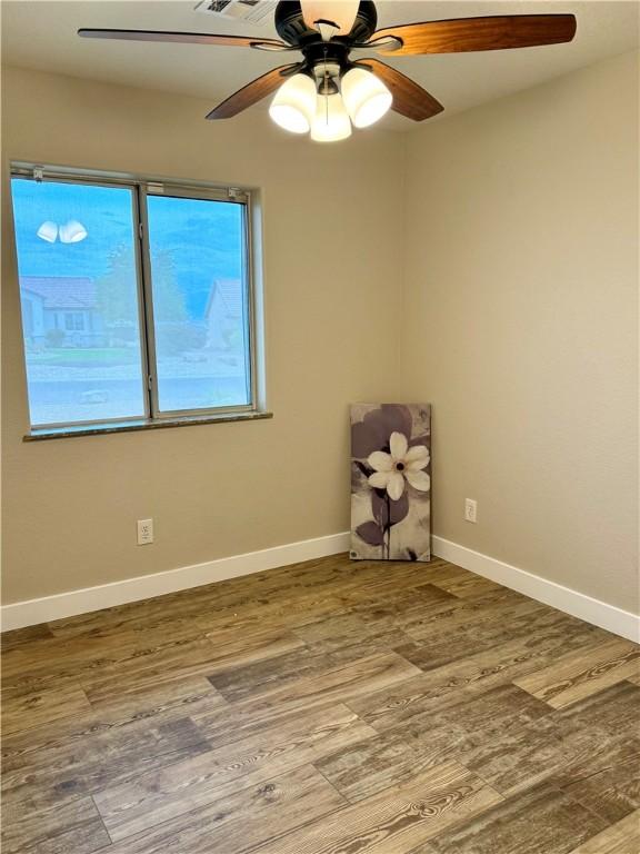 2023 E Sundance Dr, Fort Mohave, AZ 86426 - unfurnished room featuring wood finished floors, baseboards, and ceiling fan