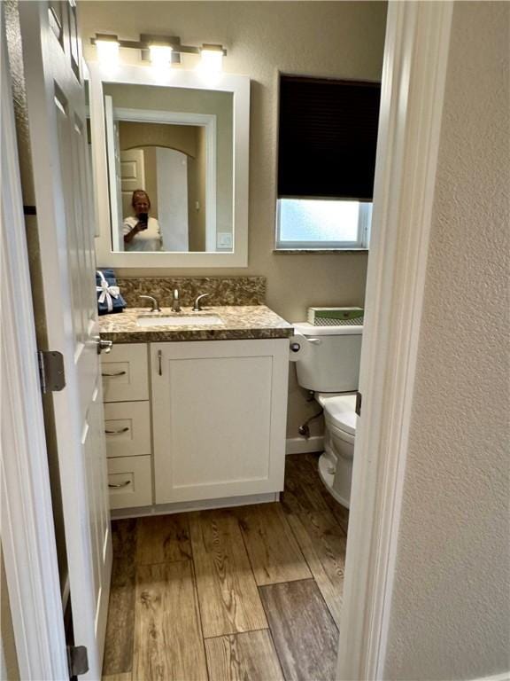2023 E Sundance Dr, Fort Mohave, AZ 86426 - half bathroom with wood finished floors, toilet, vanity, and a textured wall