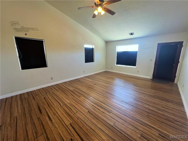 unfurnished room with a ceiling fan, baseboards, visible vents, and wood finished floors