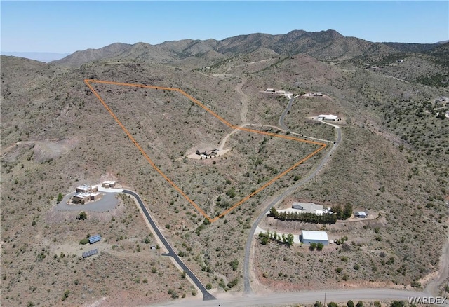 drone / aerial view with view of desert and a mountain view