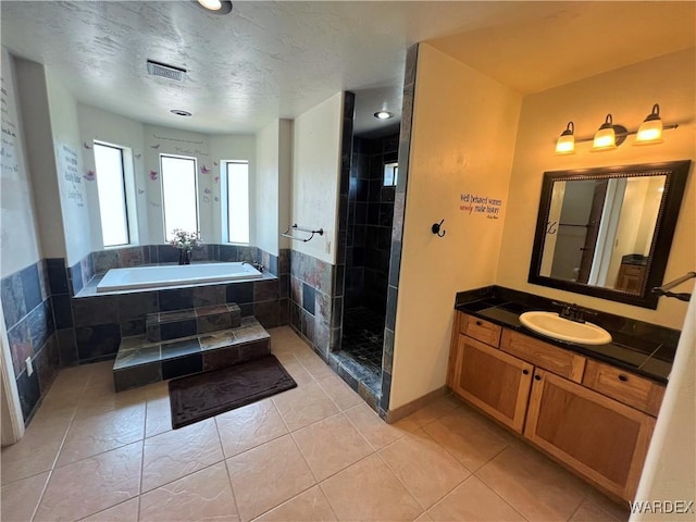 full bath with visible vents, tile patterned floors, vanity, a shower stall, and a bath