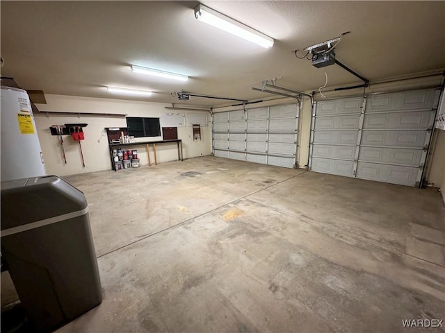 garage with water heater and a garage door opener