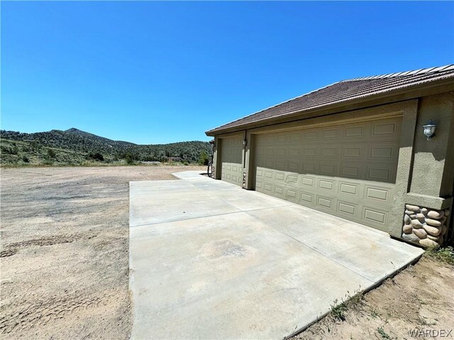 view of yard featuring a mountain view and a patio