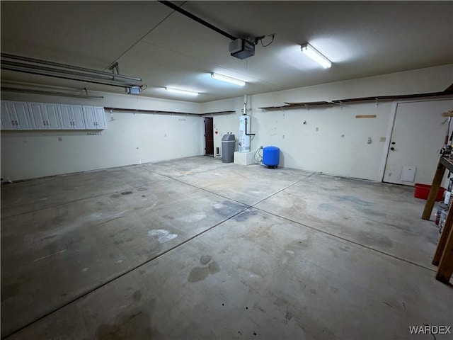 garage with a garage door opener and water heater