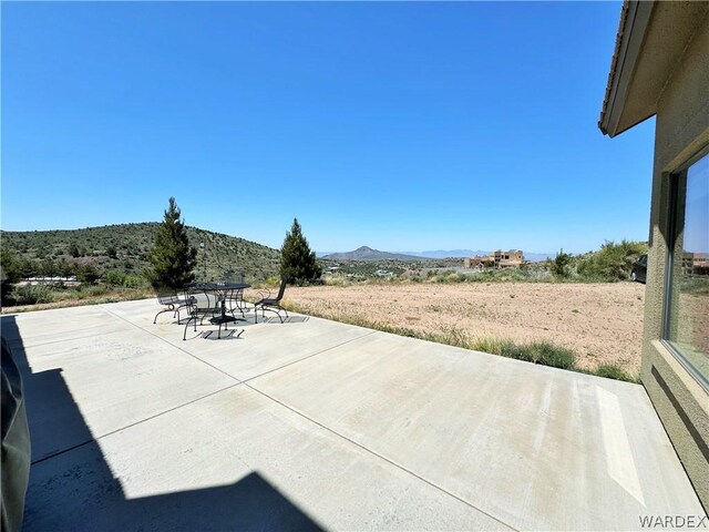 view of patio featuring outdoor dining area and a mountain view