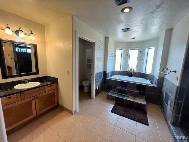 bathroom featuring a sink, baseboards, and tile patterned floors