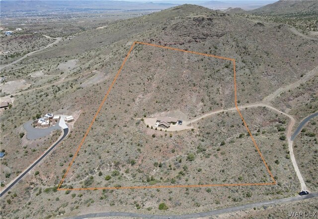 birds eye view of property featuring view of desert and a mountain view