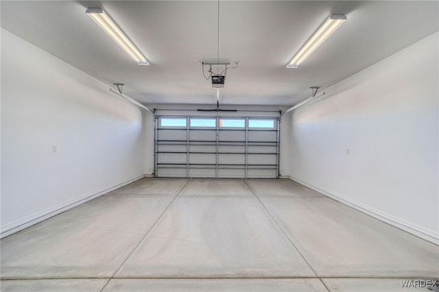 garage with baseboards and a garage door opener