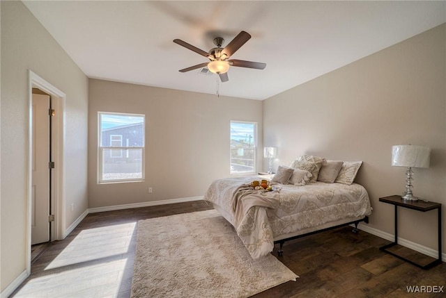 bedroom featuring dark wood-style floors, ceiling fan, and baseboards