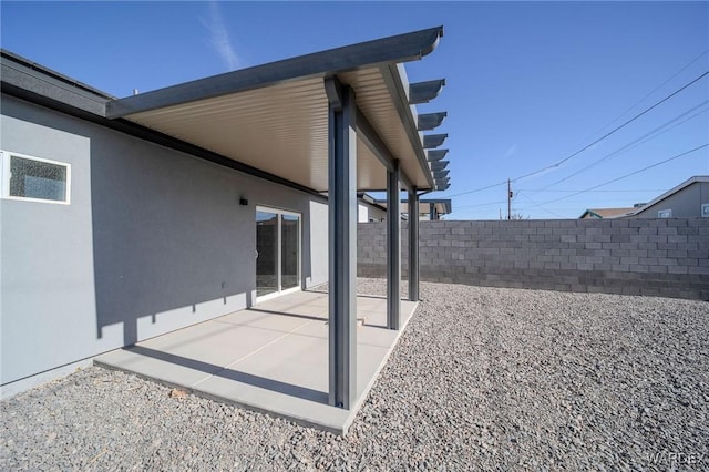 exterior space featuring fence and a patio