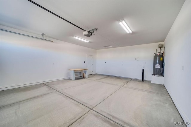 garage featuring water heater, baseboards, and a garage door opener