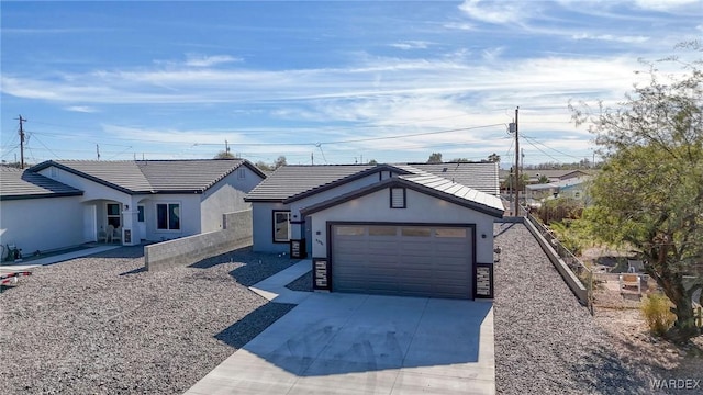 single story home with driveway, an attached garage, and stucco siding