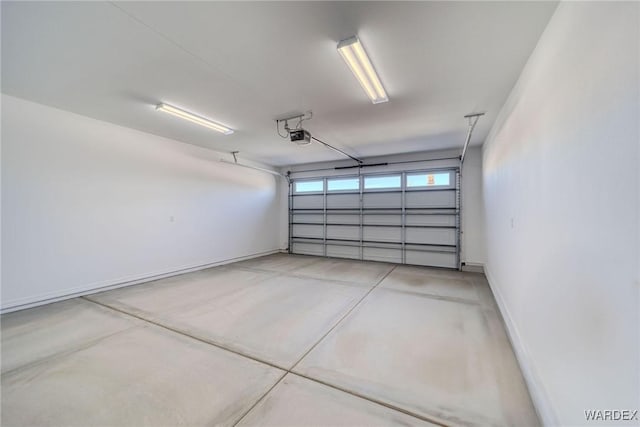 garage with a garage door opener and baseboards