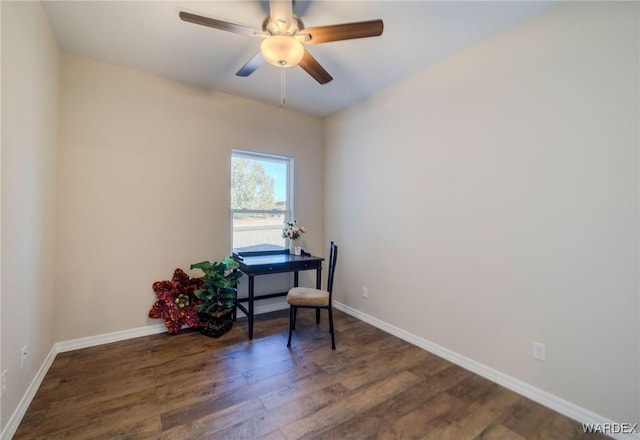 interior space featuring dark wood-type flooring, a ceiling fan, and baseboards