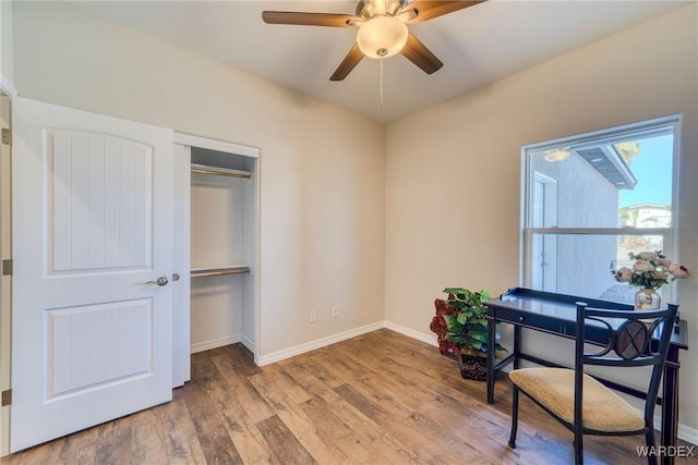 office area featuring ceiling fan, baseboards, and wood finished floors