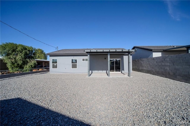 back of house featuring a patio and fence