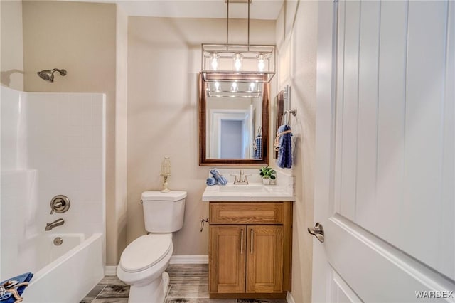 bathroom featuring toilet, shower / tub combination, baseboards, and vanity