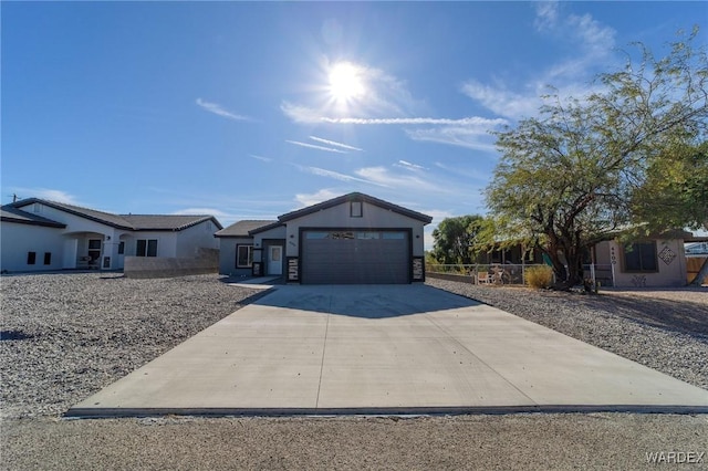 view of front of home featuring a garage, driveway, and stucco siding