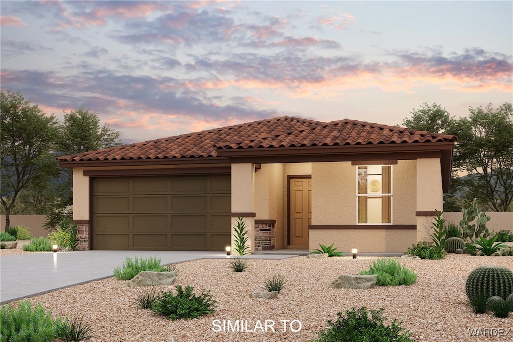 mediterranean / spanish home with stucco siding, driveway, and a garage