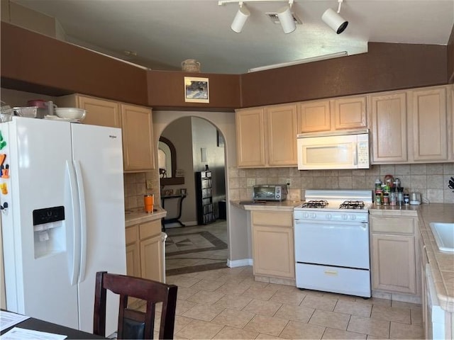 3454 Beale St, Bullhead City, AZ 86442 - kitchen featuring white appliances, arched walkways, backsplash, tile countertops, and light tile patterned floors