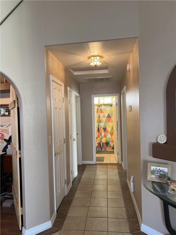 3454 Beale St, Bullhead City, AZ 86442 - hall featuring arched walkways, tile patterned floors, and baseboards
