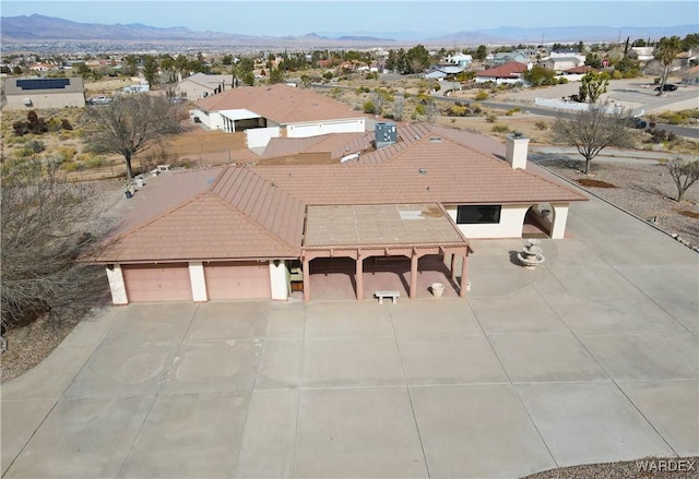 drone / aerial view featuring a residential view and a mountain view