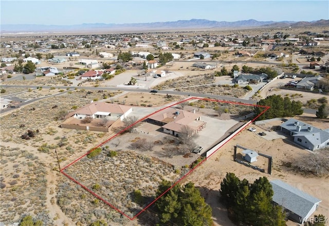 drone / aerial view featuring a mountain view and view of desert