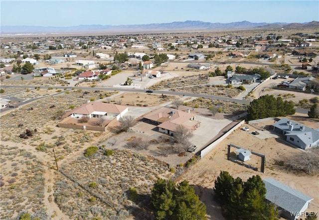 birds eye view of property with a residential view, a desert view, and a mountain view