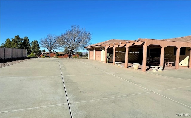 exterior space with fence and concrete driveway