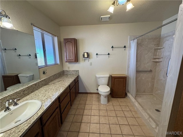 full bathroom with toilet, curtained shower, vanity, and tile patterned floors