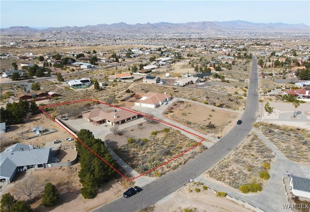 aerial view with a residential view, view of desert, and a mountain view