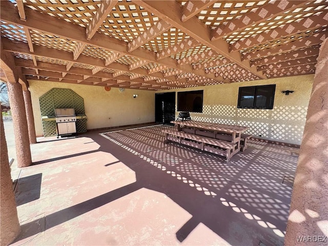 view of patio featuring area for grilling and a pergola