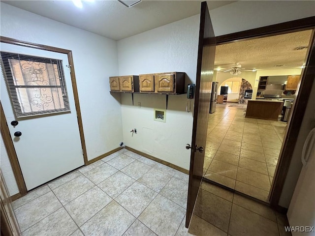 clothes washing area with a textured ceiling, light tile patterned floors, hookup for a washing machine, a ceiling fan, and baseboards