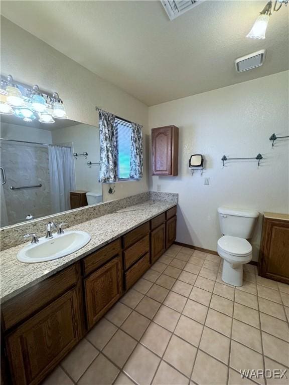 bathroom featuring tile patterned flooring, toilet, a shower with shower curtain, vanity, and visible vents