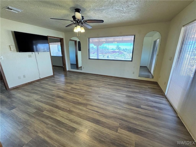 interior space featuring visible vents, arched walkways, and wood finished floors