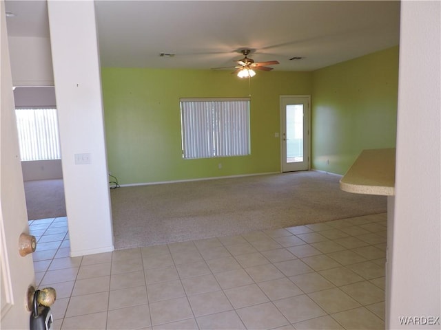 2353 Halfmoon Way, Bullhead City, AZ 86442 - unfurnished room with visible vents, light tile patterned flooring, baseboards, ceiling fan, and light colored carpet