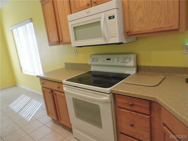 2353 Halfmoon Way, Bullhead City, AZ 86442 - kitchen with plenty of natural light, light countertops, light tile patterned floors, and white appliances