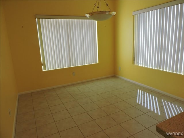 2353 Halfmoon Way, Bullhead City, AZ 86442 - tiled empty room with baseboards and a healthy amount of sunlight