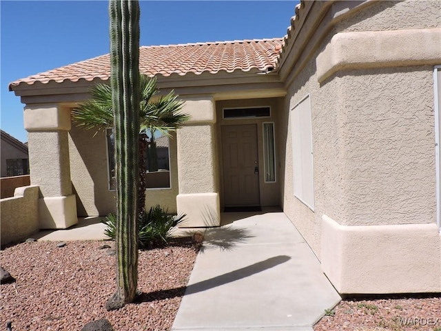 2353 Halfmoon Way, Bullhead City, AZ 86442 - doorway to property featuring stucco siding and a tile roof