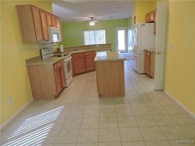 2353 Halfmoon Way, Bullhead City, AZ 86442 - kitchen with a ceiling fan, light countertops, light tile patterned floors, a peninsula, and white appliances