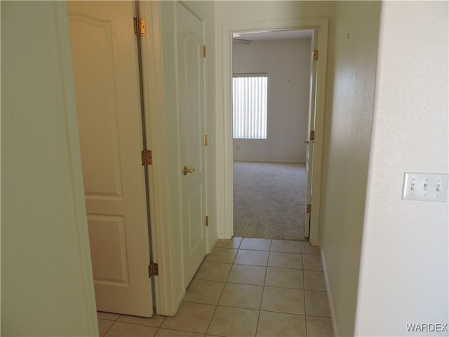 2353 Halfmoon Way, Bullhead City, AZ 86442 - hallway featuring baseboards, light tile patterned floors, and light colored carpet